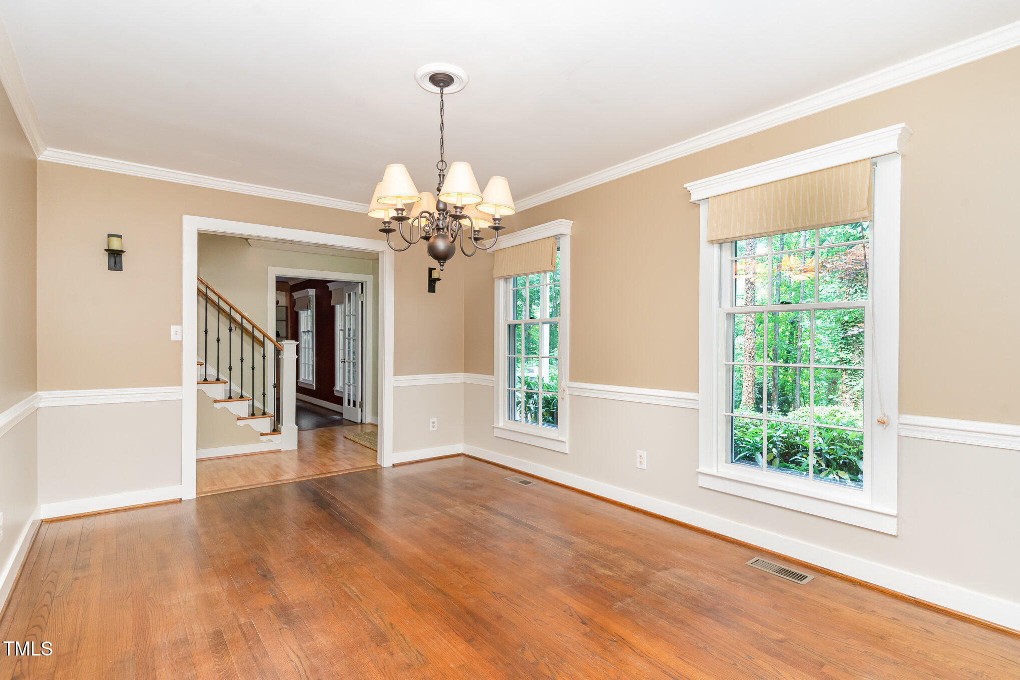 12709 Timberlane Court Raleigh, NC 27613 - Photo 11 of 44 a view of a livingroom with a chandelier wooden floor and windows