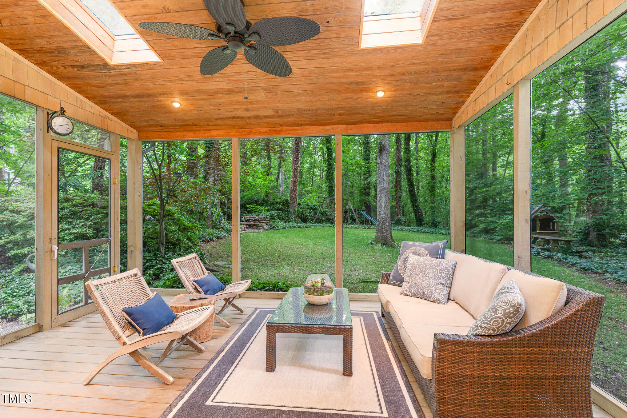 12709 Timberlane Court Raleigh, NC 27613 - Photo 2 of 44 a living room with patio furniture and a floor to ceiling windows