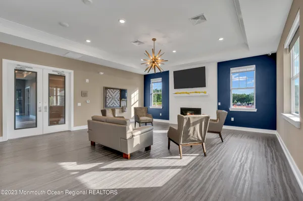 a living room with furniture a fireplace and a flat screen tv