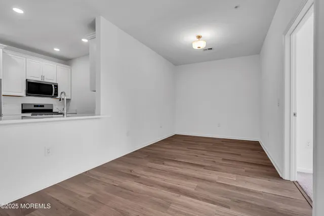 a view of a livingroom with an empty space and a window