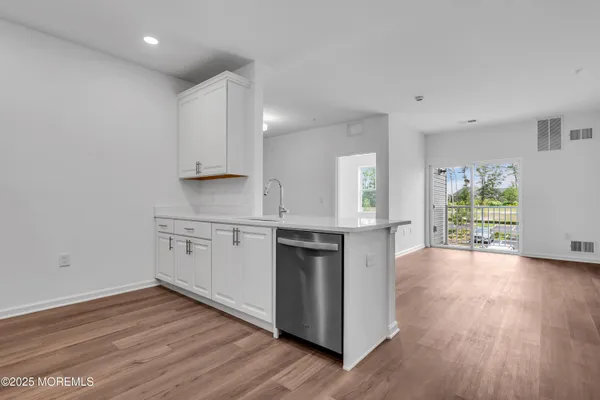 a kitchen with kitchen island a sink stainless steel appliances and refrigerator