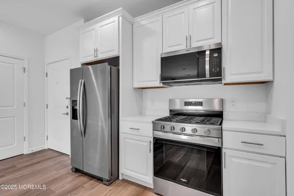 a kitchen with stainless steel appliances a refrigerator stove and microwave