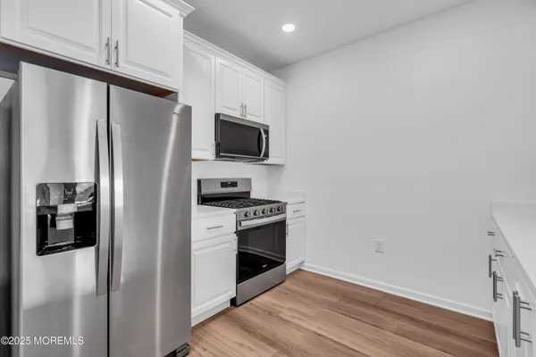 a view of cabinets with wooden floor