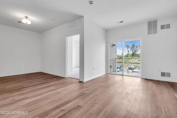 a view of a livingroom with an empty space and a window
