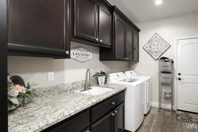 a kitchen with granite countertop stainless steel appliances a sink and cabinets