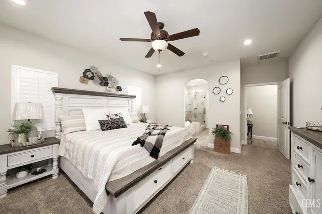 a bedroom with a bed and ceiling fan