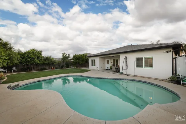 a view of a house with swimming pool and sitting area