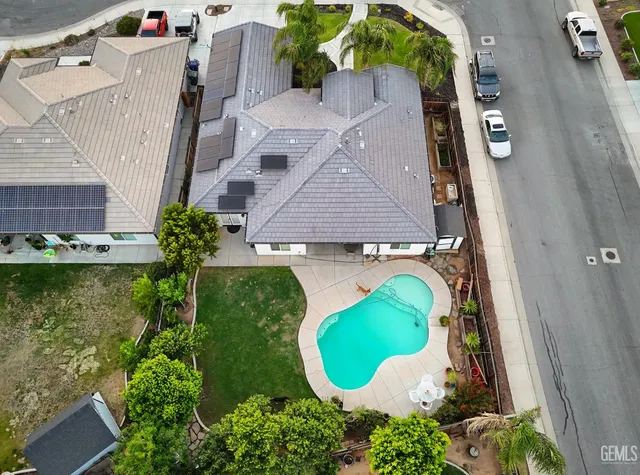 an aerial view of a house with a swimming pool