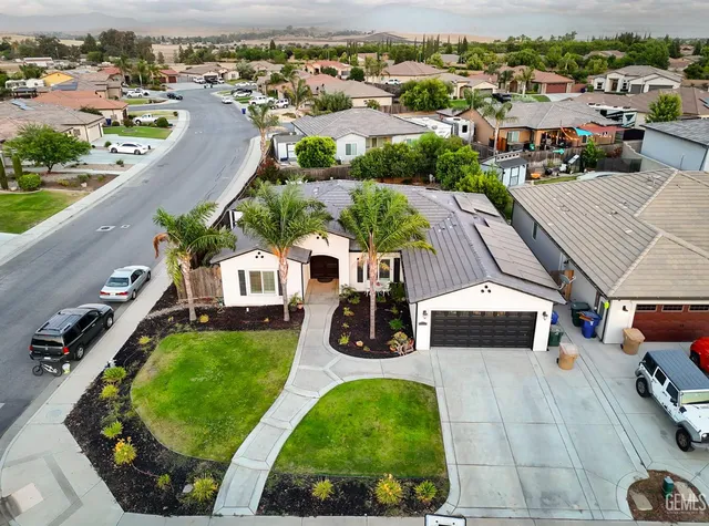 an aerial view of a house with garden space and street view