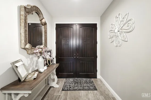 a view of a hallway with wooden floor and a dining table