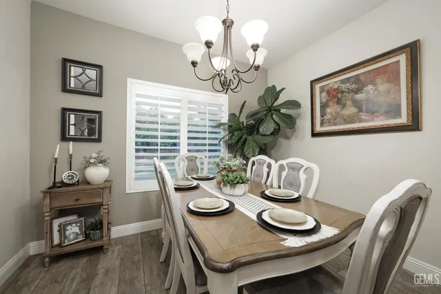 a view of a dining room with furniture wooden floor and chandelier
