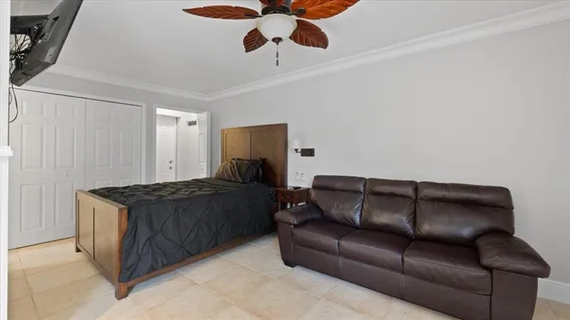 a living room with a couch and a ceiling fan