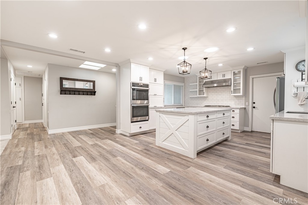 4580 Hazelnut Avenue Seal Beach, CA 90740 - Photo 13 of 35 a kitchen with stainless steel appliances kitchen island granite countertop a sink and cabinets