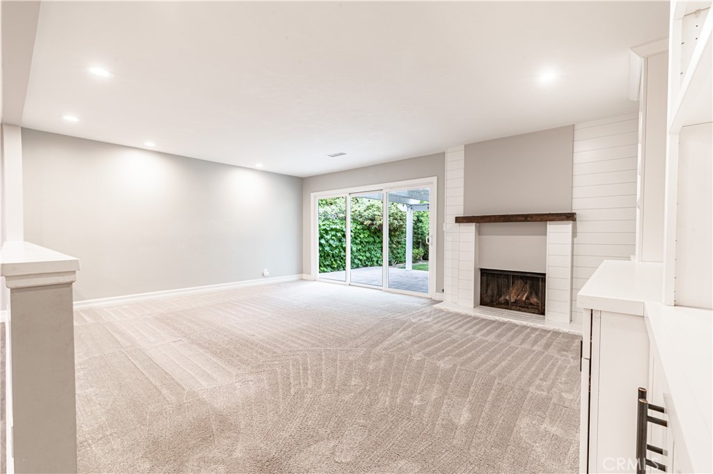 4580 Hazelnut Avenue Seal Beach, CA 90740 - Photo 17 of 35 a view of an empty room with a fireplace and a window