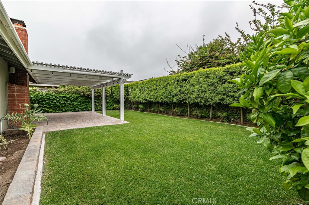 4580 Hazelnut Avenue Seal Beach, CA 90740 - Photo 31 of 35 a view of a patio with table and chairs under an umbrella