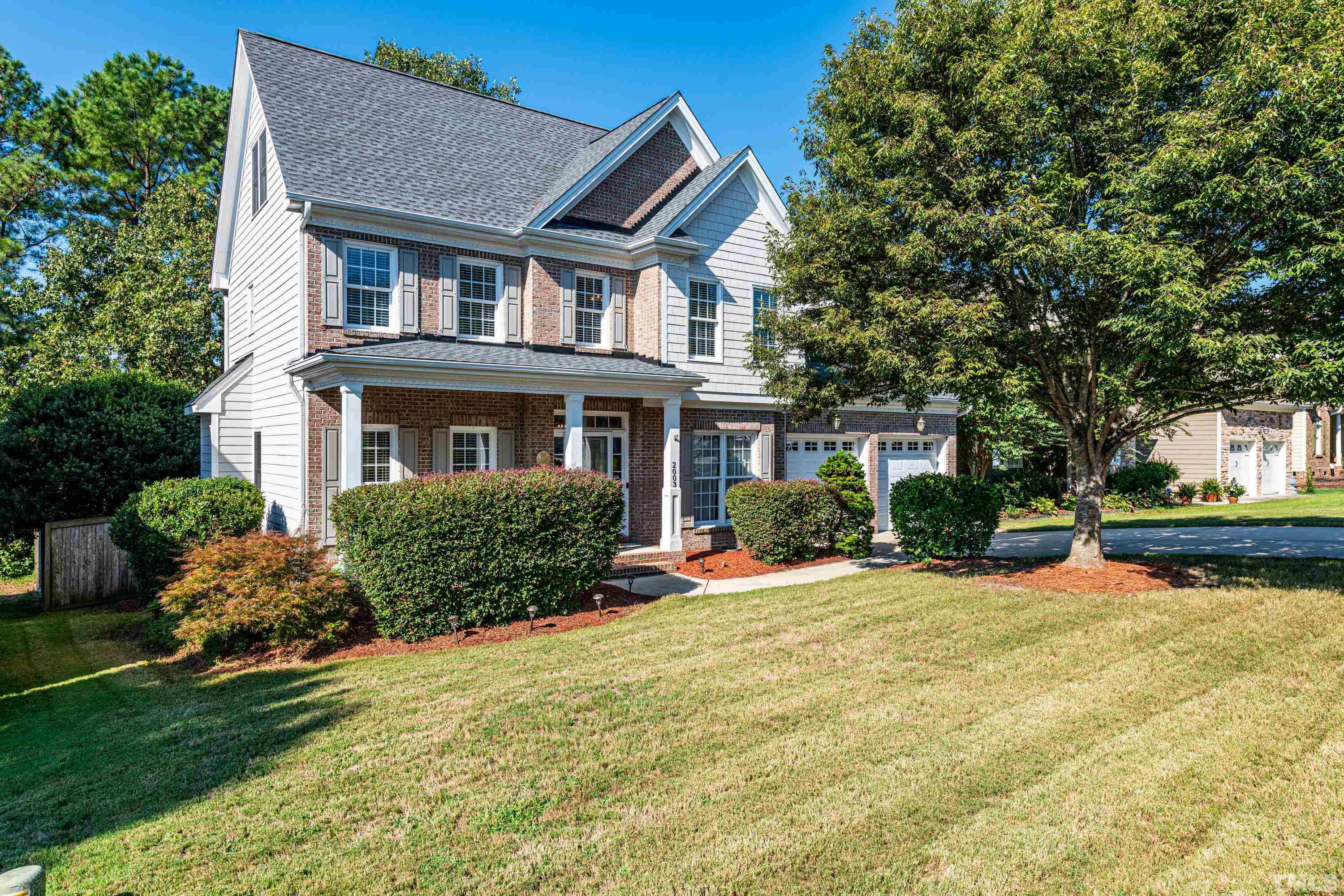 2003 River Grove Lane Knightdale, NC 27545 - Photo 1 of 51 a front view of a house with a yard table and chairs