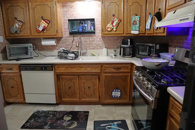 a kitchen with stainless steel appliances granite countertop a stove a cabinets and a sink