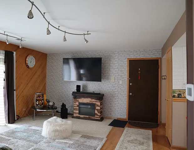 a bedroom with furniture and a flat screen tv