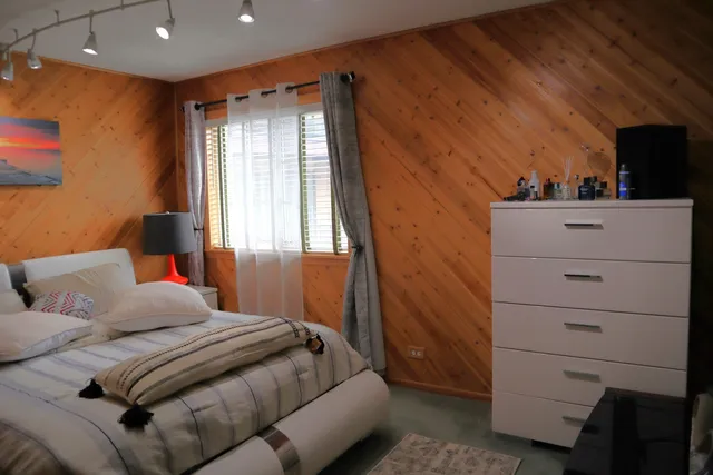 a bedroom with a bed and a dresser