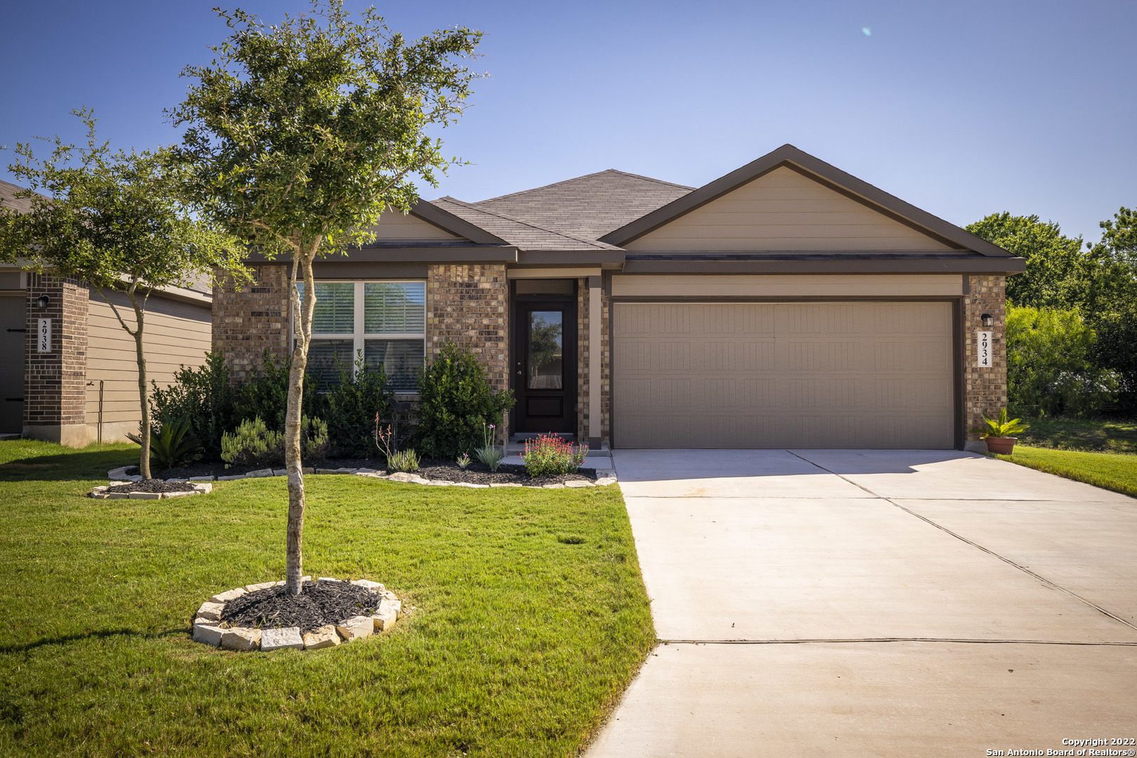 a front view of a house with a yard