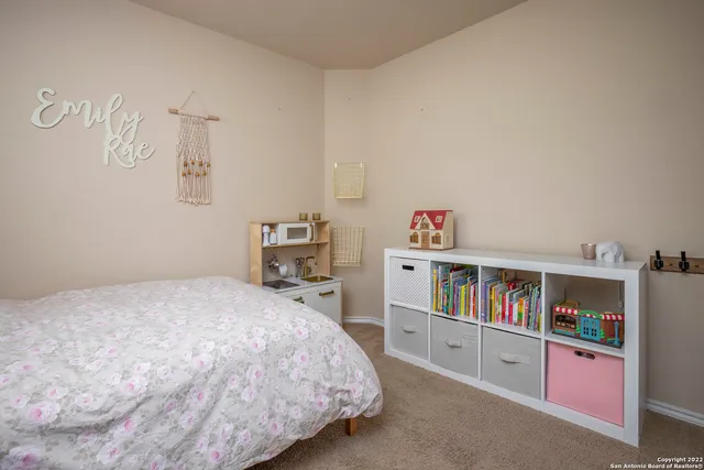 a bedroom with a bed dresser and a book shelf