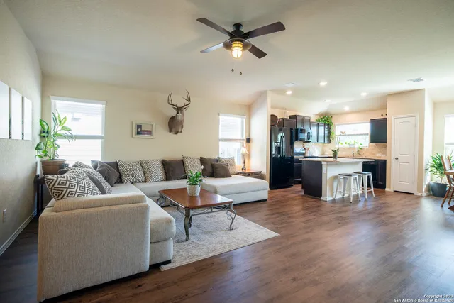 a living room with furniture and kitchen view