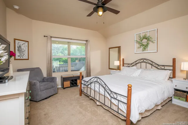 a spacious bedroom with a bed a couch and a window