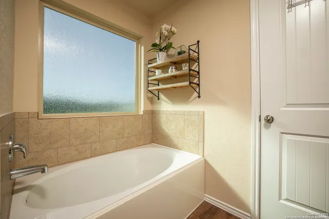a bathroom with a bathtub and a shower