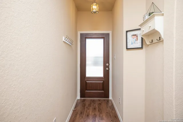 a view of a hallway with wooden floor