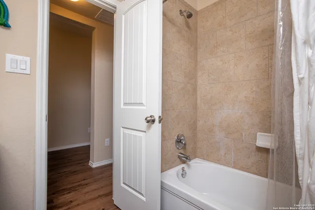 a bathroom with a bathtub and shower