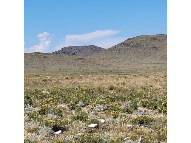 a view of a dry room with mountains in the background