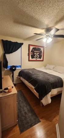 a bed sitting in a bedroom next to a lamp