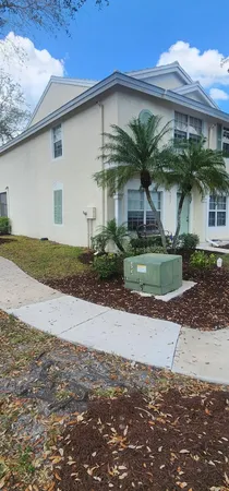 a front view of a house with plants