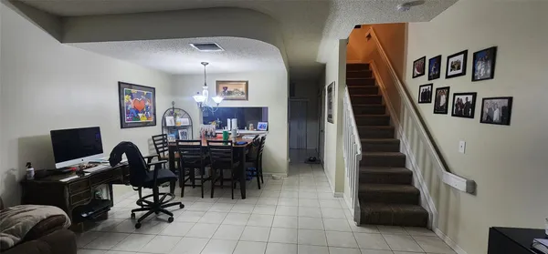 a view of a workspace with furniture and stairs