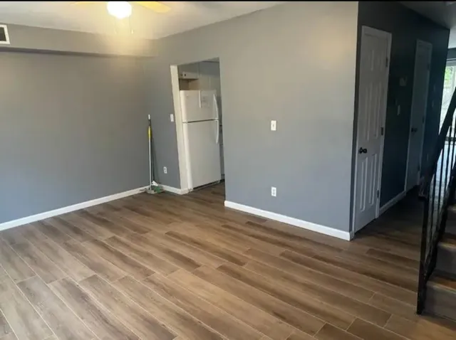 a view of a room with wooden floor