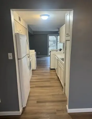 a view of entryway with furniture and wooden floor