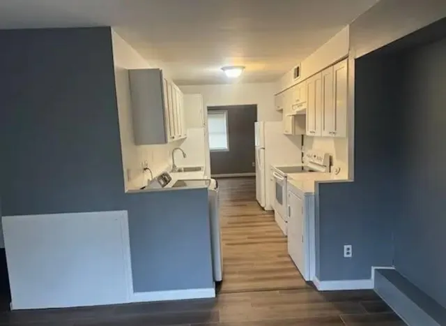 a view of hallway with wooden floor
