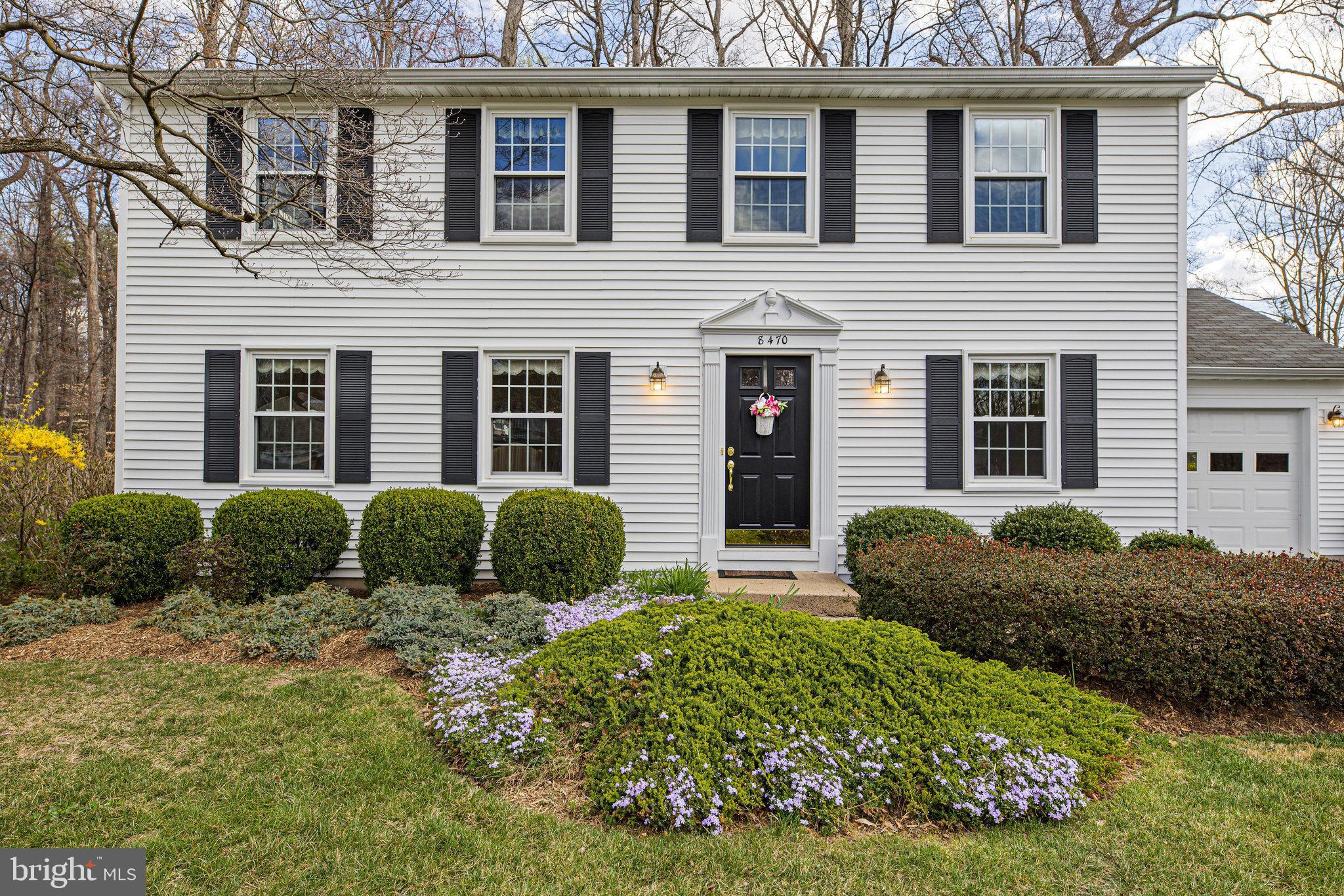 a view of a house with a yard and plants