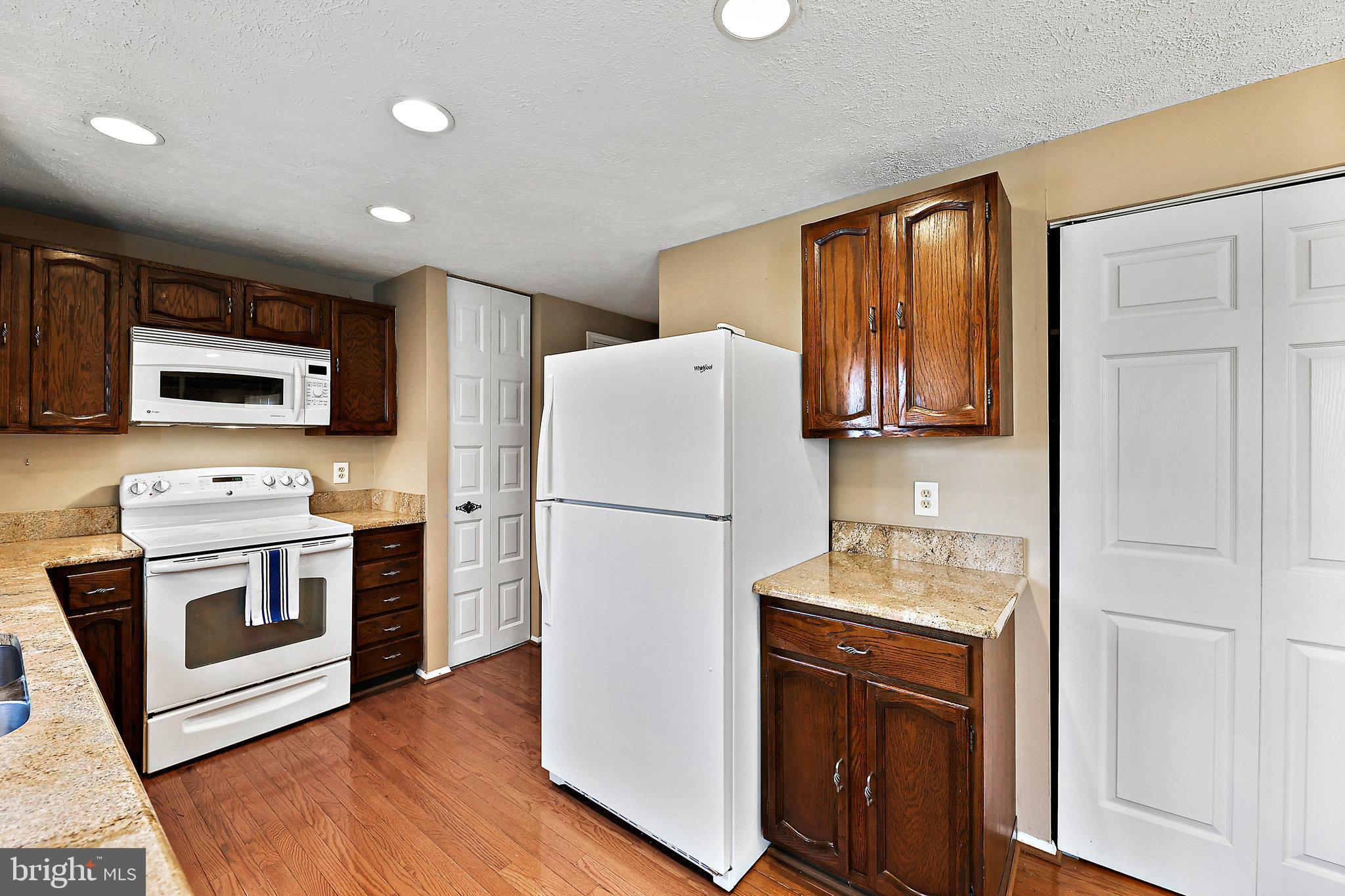 8470 Falling Leaf Road Springfield, VA 22153 - Photo 14 of 41 a white refrigerator freezer sitting in a kitchen