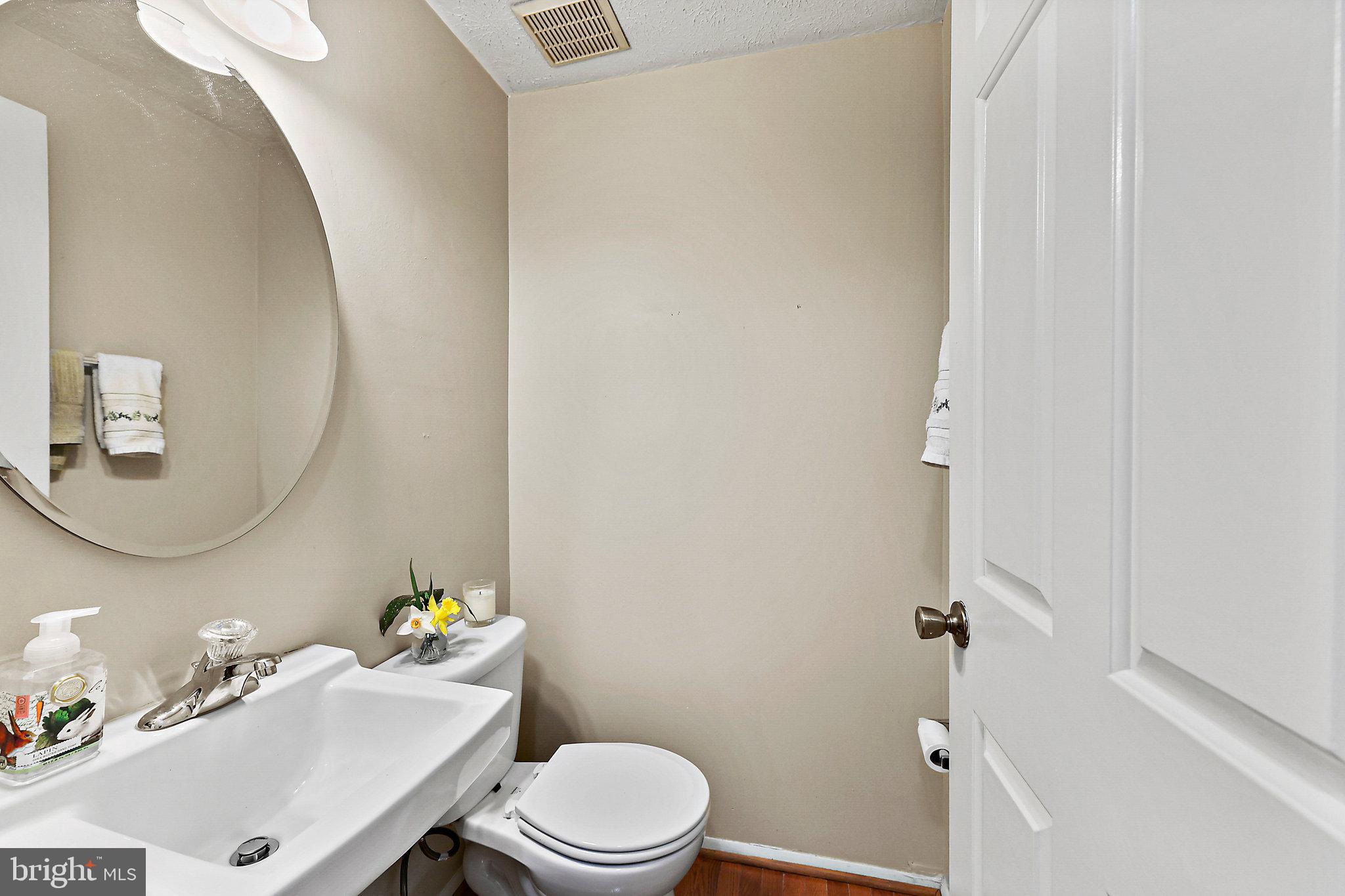 8470 Falling Leaf Road Springfield, VA 22153 - Photo 19 of 41 a white toilet sitting next to a bathroom sink