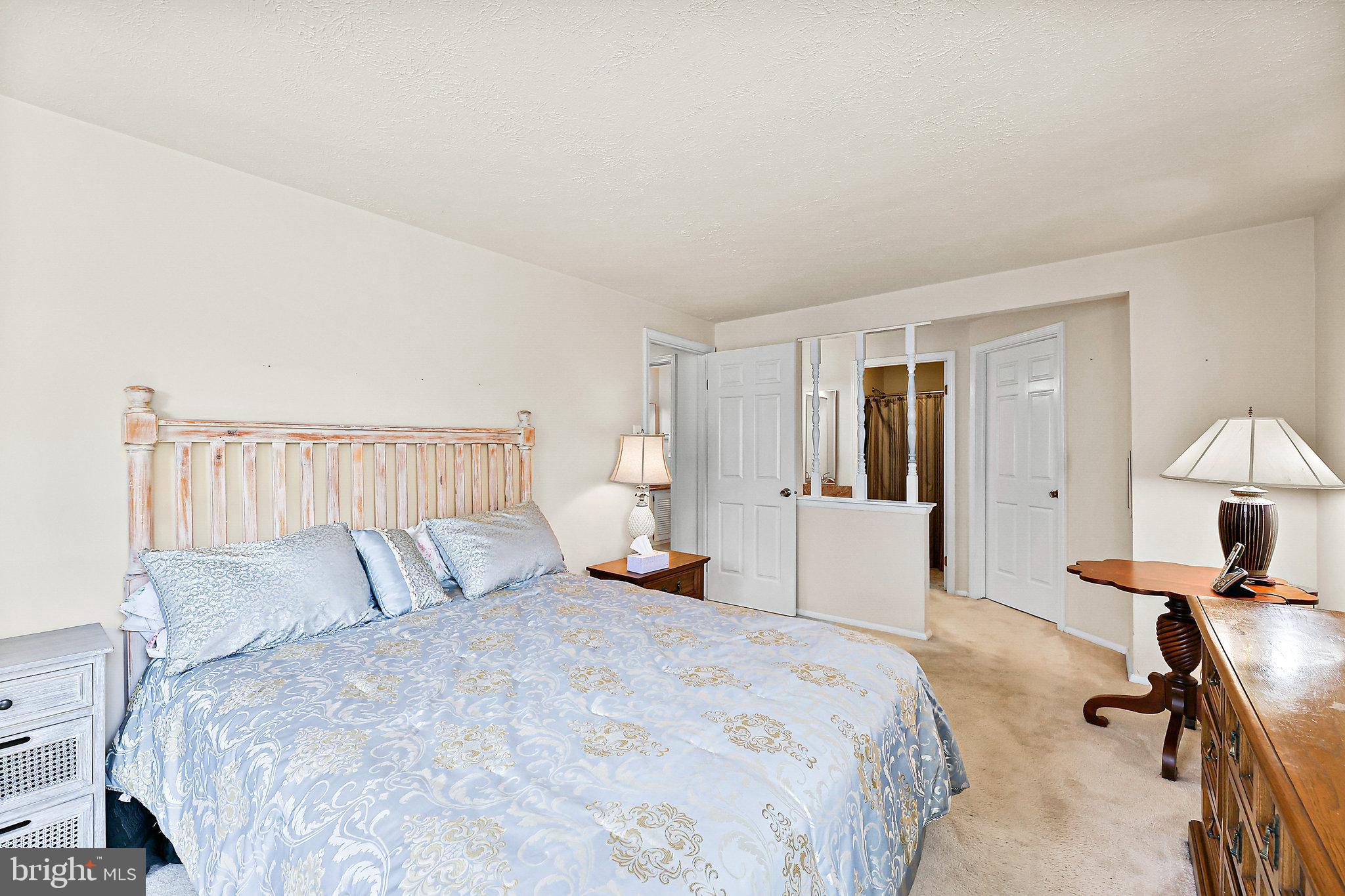 8470 Falling Leaf Road Springfield, VA 22153 - Photo 22 of 41 a bedroom with a bed and a chandelier