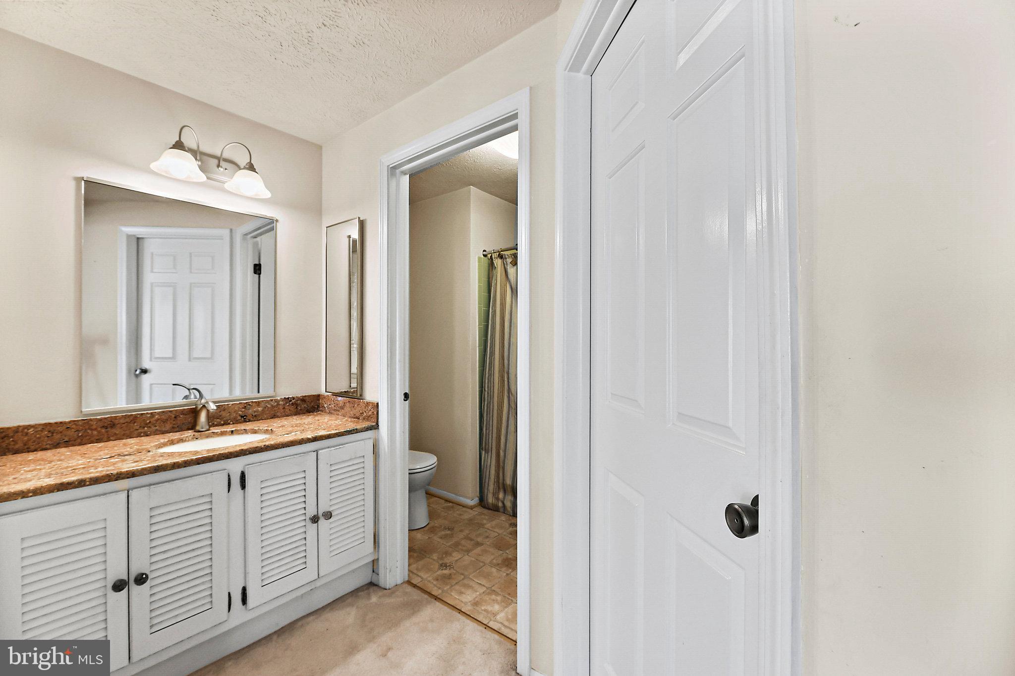 8470 Falling Leaf Road Springfield, VA 22153 - Photo 23 of 41 a spacious bathroom with a double vanity sink and a mirror