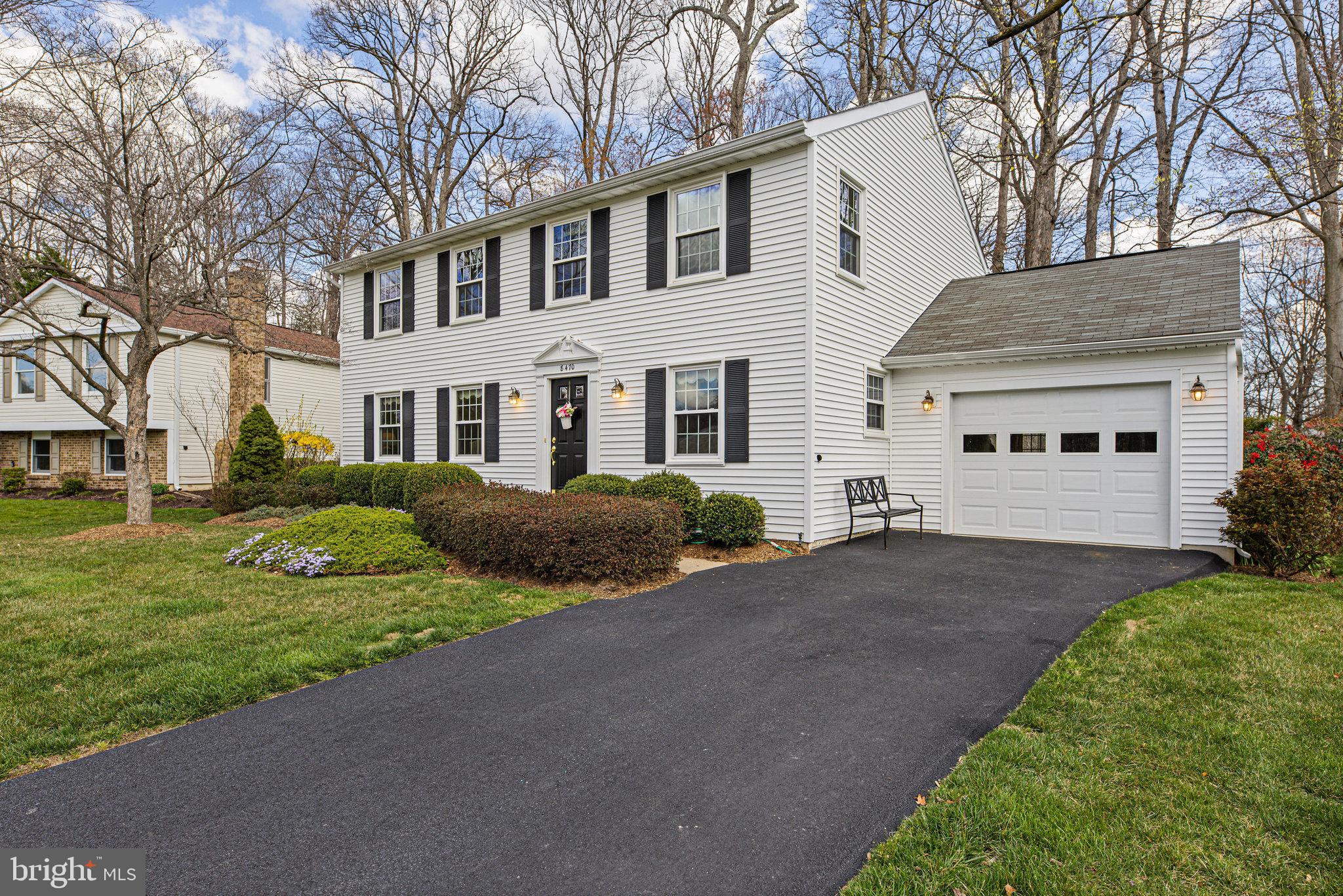 8470 Falling Leaf Road Springfield, VA 22153 - Photo 3 of 41 a front view of a house with a garden and trees
