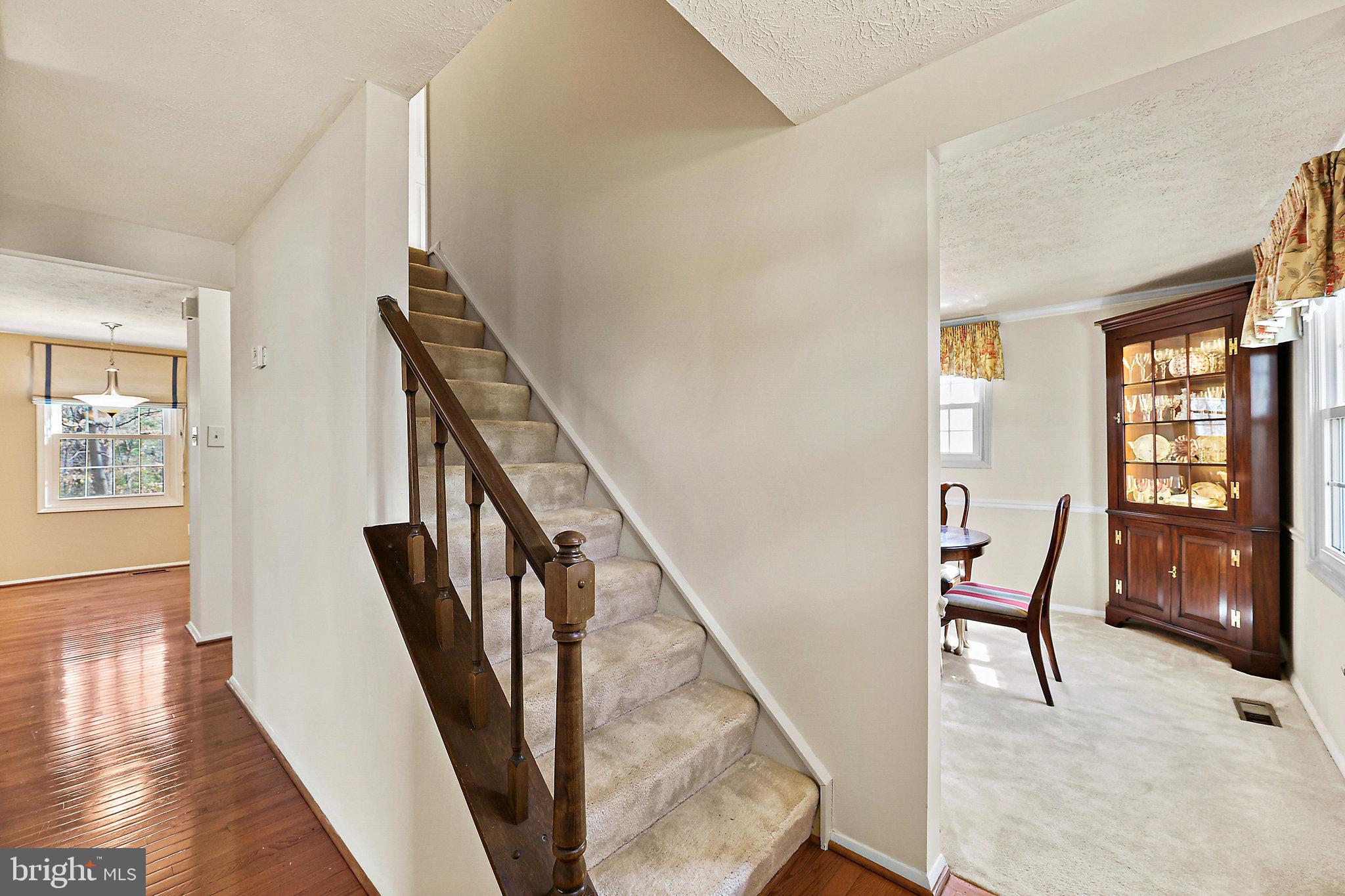 8470 Falling Leaf Road Springfield, VA 22153 - Photo 6 of 41 a view of an entryway with wooden floor and stairs