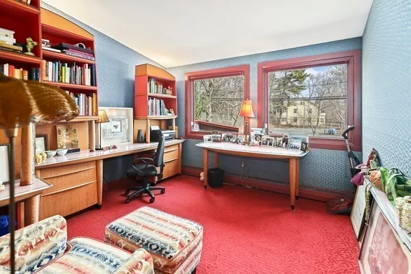 a living room with furniture and a book shelf