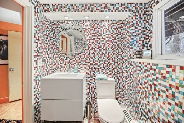 a bathroom with a toilet and a shower curtain