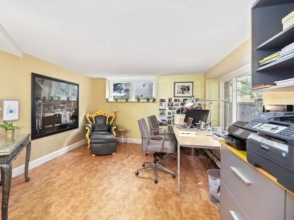 a living room with furniture and a dining table with wooden floor