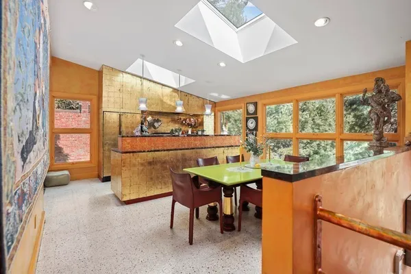 a dining room with furniture and a large window