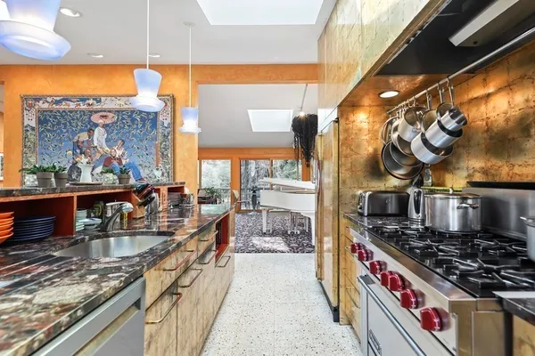 a kitchen with stainless steel appliances granite countertop a stove and a sink