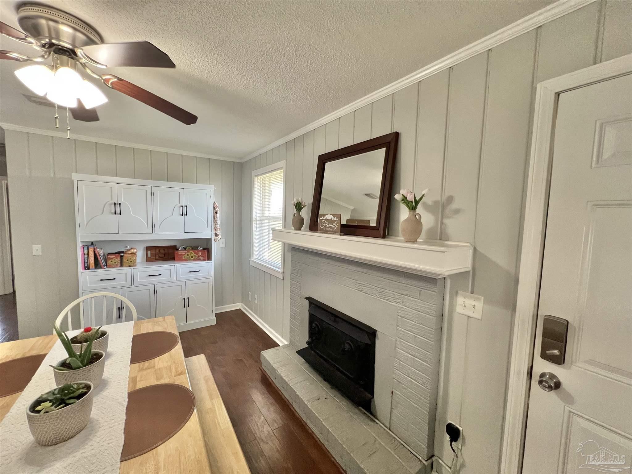 4075 Macks Road Century, FL 32535 - Photo 11 of 45 a living room with furniture and a fireplace